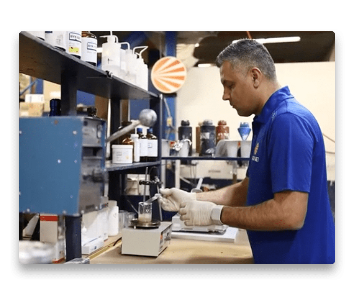 An image showing a paint formulator making kitchen cabinet paint in a lab.